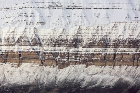 Snow covered Carboniferous mountain slope showing strata in autumn, Billefjord, Billefjorden,