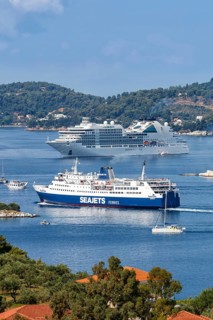 Cruise ship ferry and boats in the sea off the Mediterranean island of Skiathos, Greece, Europe
