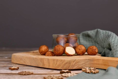 L German Christmas sweets called 'Marzipankartoffeln'. Round ball shaped almond paste pieces