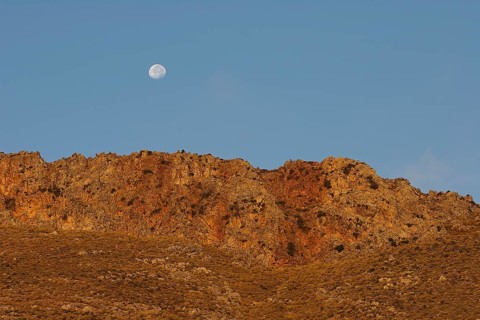 Golden morning light, moon over mountain range, Gramvoussa peninsula, Pirate Bay, Balos, Tigani,