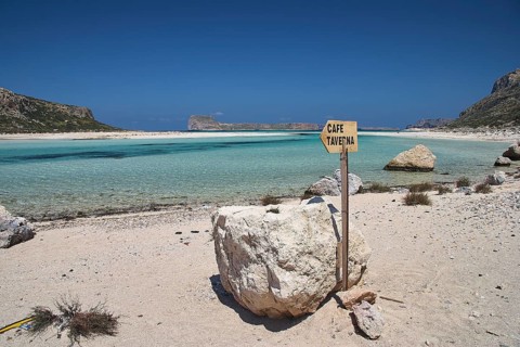 Beach, lagoon, Gramvoussa Island, sign Cafe Taverna, blue cloudless sky, Gramvoussa Peninsula,