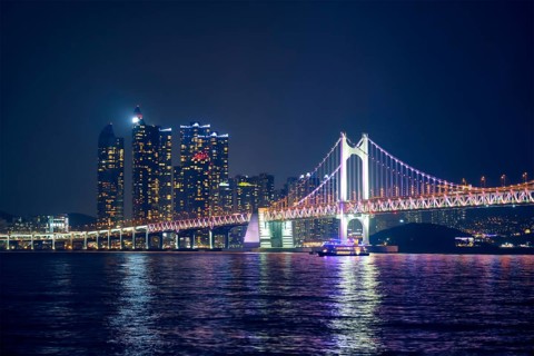 Gwangan Bridge and skyscrapers illuminated in the night. Busan, South Korea, Asia