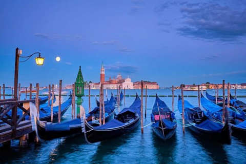 Romantic vacation Venice travel background, gondolas at Saint Mark (San Marco) square and Basilica