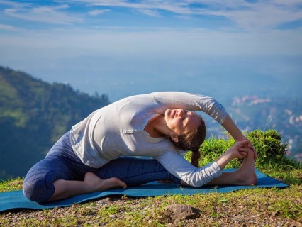 Yoga outdoors, young sporty fit woman doing Hatha Yoga asana parivritta janu sirsasana, Revolved