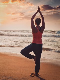 Vintage retro effect filtered hipster style image of Yoga outdoors, sporty fit woman doing Hatha