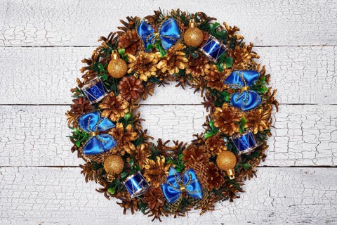 Christmas wreath on white painted wooden background