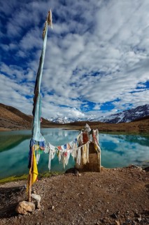 Small gompa with buddhist prayer flags at sacred Dhankar Lake. Spiti Valley, Himachal Pradesh,