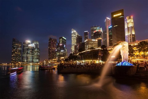 SINGAPORE, JANUARY 1, 2014: Night view of Singapore Merlion at Marina Bay against Singapore skyline
