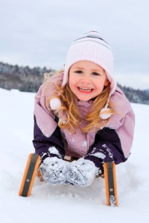 Girl on sleigh, Switzerland, Europe