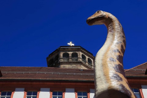 Dinosaur figure in the city centre of Bayreuth, advertising for the primeval world museum in the