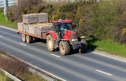 CASE 165 tractor with trailer carrying seed potatoes, A12, Suffolk, England, UK