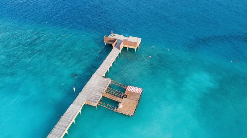 Aerial view bird's eye view of jetty of Maldives Island of Maldives, in foreground jetty for