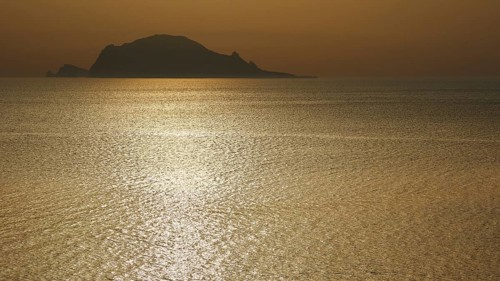 Santa Marina Salina, sunrise, sun rises behind Panarea, Panarea island near, light reflections on