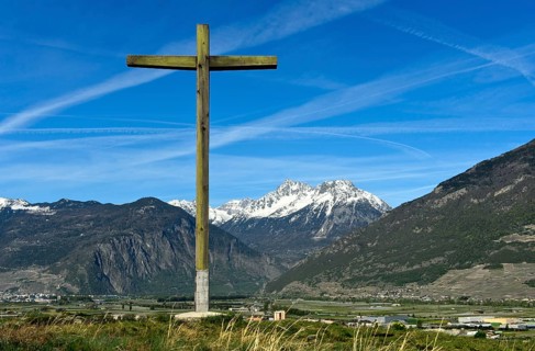Wooden cross visible from afar on a hill above the Rhone valley in Lower Valais, Charrat, Valais,