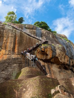 Visitors climb the stairs at Sigiriya Rock, Sri Lanka, Asia
