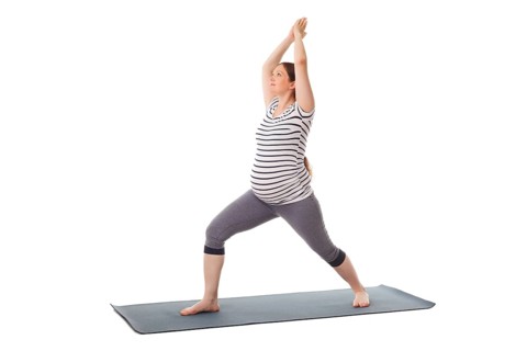 Pregnancy yoga exercise, pregnant woman doing asana virabhadrasana 1, warrior pose isolated on