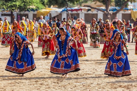 PUSHKAR, INDIA, NOVEMBER 21, 2012: Unidentified Rajasthani girls in traditional outfits dancing at