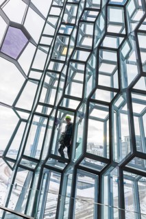 Window cleaners cleaning the glass facade of the Harpa Concert Hall and Congress Centre, interior
