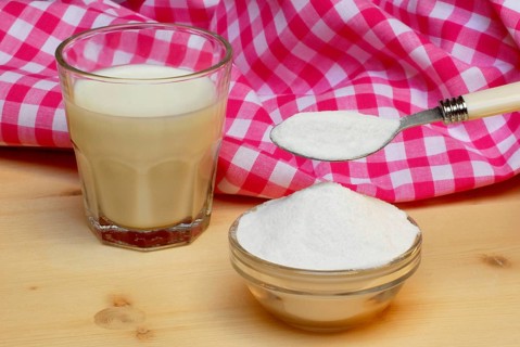 Glass of milk and bowl with lactose, lactose, sugar