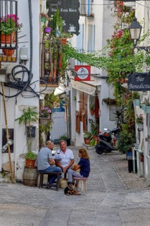 People in a sidewalk café in the old town of Peñíscola, Castellón province, Costa del Azahar,