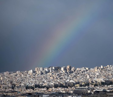 View over the sea of houses of Athens, with rainbow, Athens, Attica, Greece, Europe
