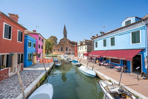 Colourful houses on the canal with reflection, canal with boats and colourful house facades, in the