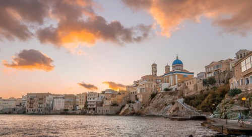 View of the village with the Greek Orthodox church of Agios Nikolaos, Asteria Beach, at sunset with
