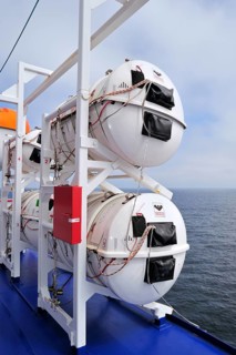 Inflatable life rafts in hard-shell canisters on board a ferry boat