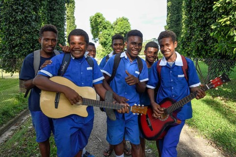 Pupils of the Catholic mission station of Vunapope in school uniforms and with guitars, Kokopo,
