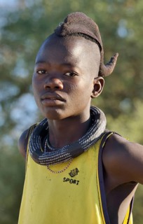 Young Himba boy wearing a traditional headdress, Omohanja, Kaokoland, Kunene, Namibia, Africa