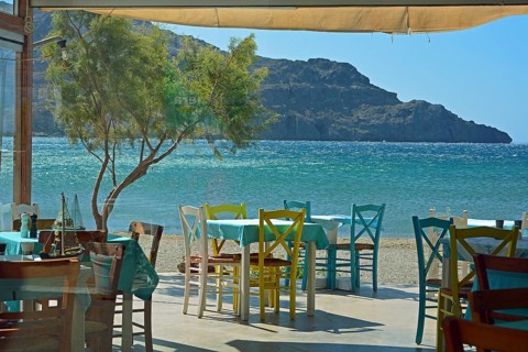 Gastronomy, colourful tables and chairs on the beach, Plakias, Crete, Greece, Europe