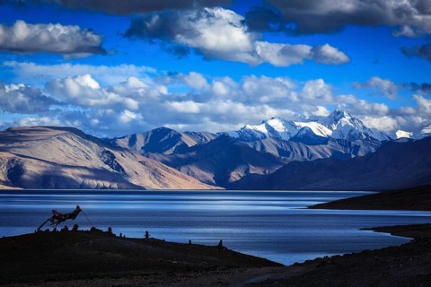 Buddhist prayer flags lungta at Himalayan lake Tso Moriri on sunset, Korzok, Ladakh, India, Asia