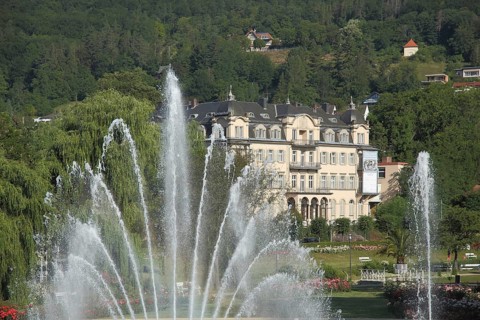 Water fountain, water features and water jets in the Rose Park with a view of Fürstenhof in Bad