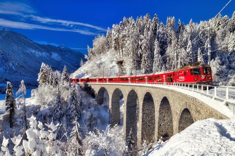Rhaetian railway on viaduct in winter landscape, near Filisur, Canton Graubünden, Switzerland,