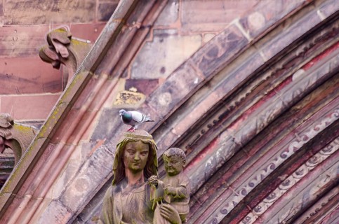 Sculpture of Mother Mary with Child Jesus in front of the main portal of Freiburg Cathedral, also
