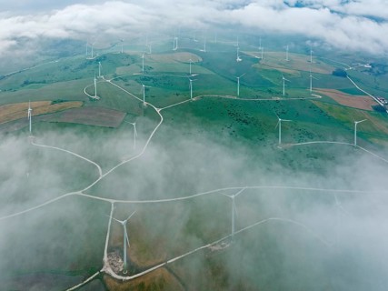 Windmills on a wind farm near Zahara de los Atunes, at a cloudy morning, aerial view, drone shot,
