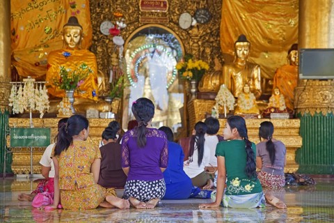 Burmese women praying barefooted in the Shwedagon Zedi Daw Pagoda at Yangon, Rangoon, former