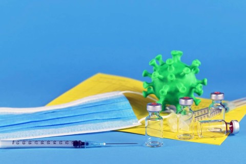Corina virus booster vaccination concept with 4 vials and syringes, vaccination passport, virus