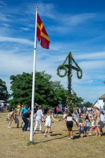 Traditional midsummer celebration with dancing around the maypole at Smygehuk, Smygehamn,