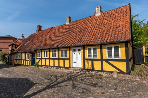 Svendborg Old Town, yellow half-timbered house, door, red roof tiles, chimneys, cobblestones, Fyn,