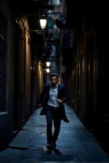 Man fleeing down a narrow dimly lit alleyway urban setting at nighttime, AI generated
