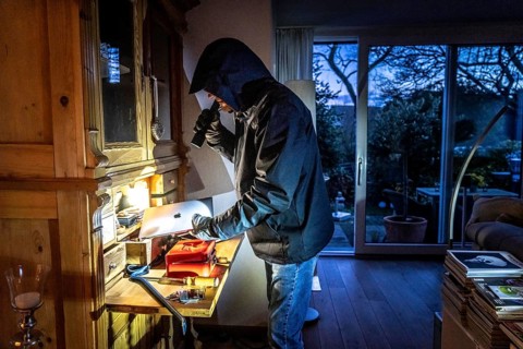 Symbolic image of a burglary, perpetrator has broken into a flat from the garden side and is