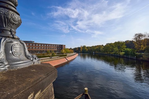 Spree with Magnus-Hirschfeld-Ufer from the Luther Bridge with historical lamppost in Berlin,