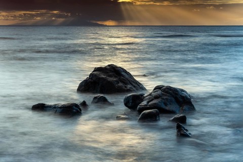 Rocks on the beach of Playa del Inglés. Sunset. Sea and waves. Long exposure. Valle Gran Rey, La