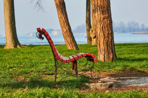 Park bench in a park at the harbor of Murano, Venice, Italy, Europe