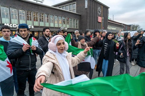 Syrian woman celebrate the end of the Assad regime after the change of power in Syria at a rally on