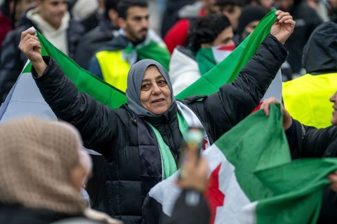 Syrian woman celebrate the end of the Assad regime after the change of power in Syria at a rally on