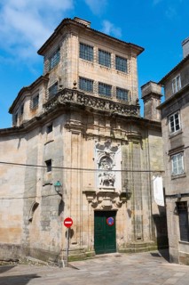 A historic building with a baroque stone façade in sunny weather, Monasterio de San Paio de