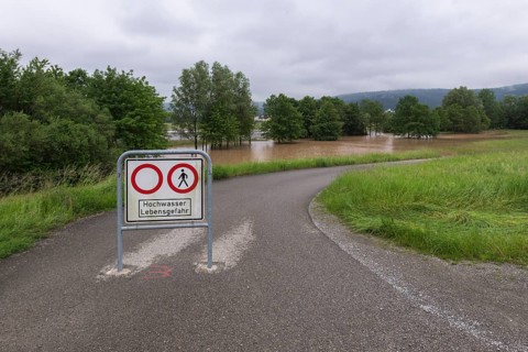 Symbolic image extreme weather, global warming, climate change, information board, flood retention
