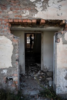 Entrance to an abandoned ruined residential building, old Soviet apartment blocks in the ghost